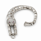 Silver panther bracelet with clear pavé stones and pink-red eyes on a white background.