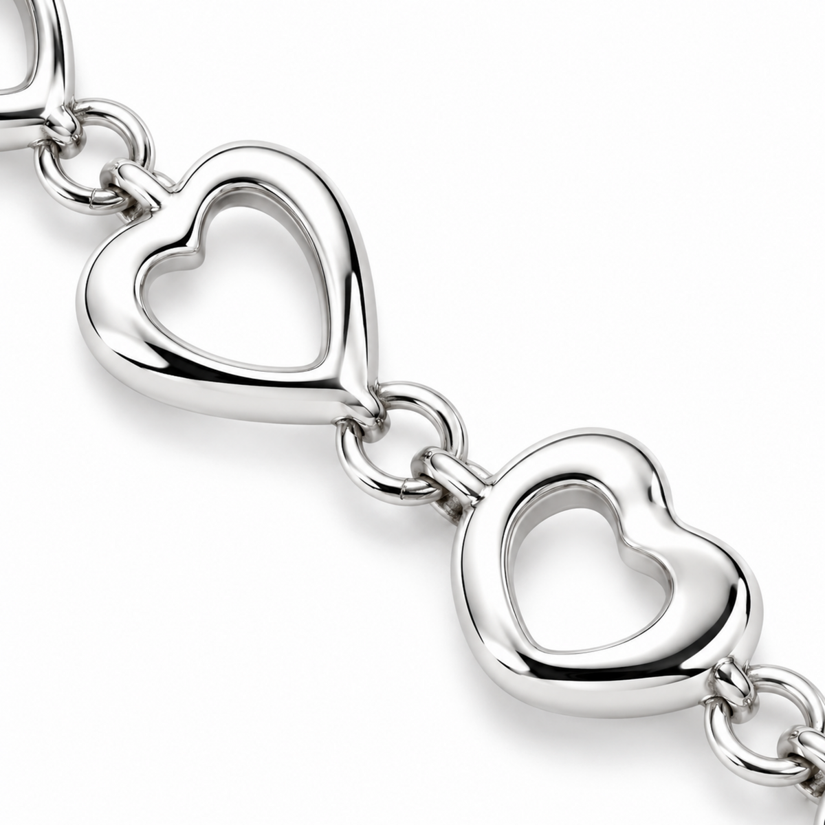 Close-up of the polished open-heart links and connecting rings on the silver bracelet.