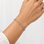 Woman wearing a delicate 925 sterling silver heart link bracelet on her wrist.