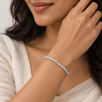 Woman wearing a silver clear stone tennis bracelet  
