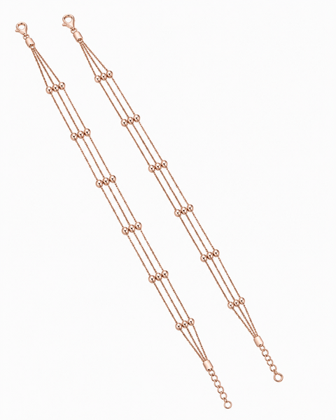 A rose gold multi-strand chain bracelet with small bead accents, displayed diagonally on a clean white background.
