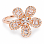 Close-up: Close-up of baguette-cut stones, round stone borders and centre cluster on rose-gold flower ring