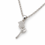 Second angle: Angled view of silver rose pendant showing its clear-stone flower, open leaf, and curved stem