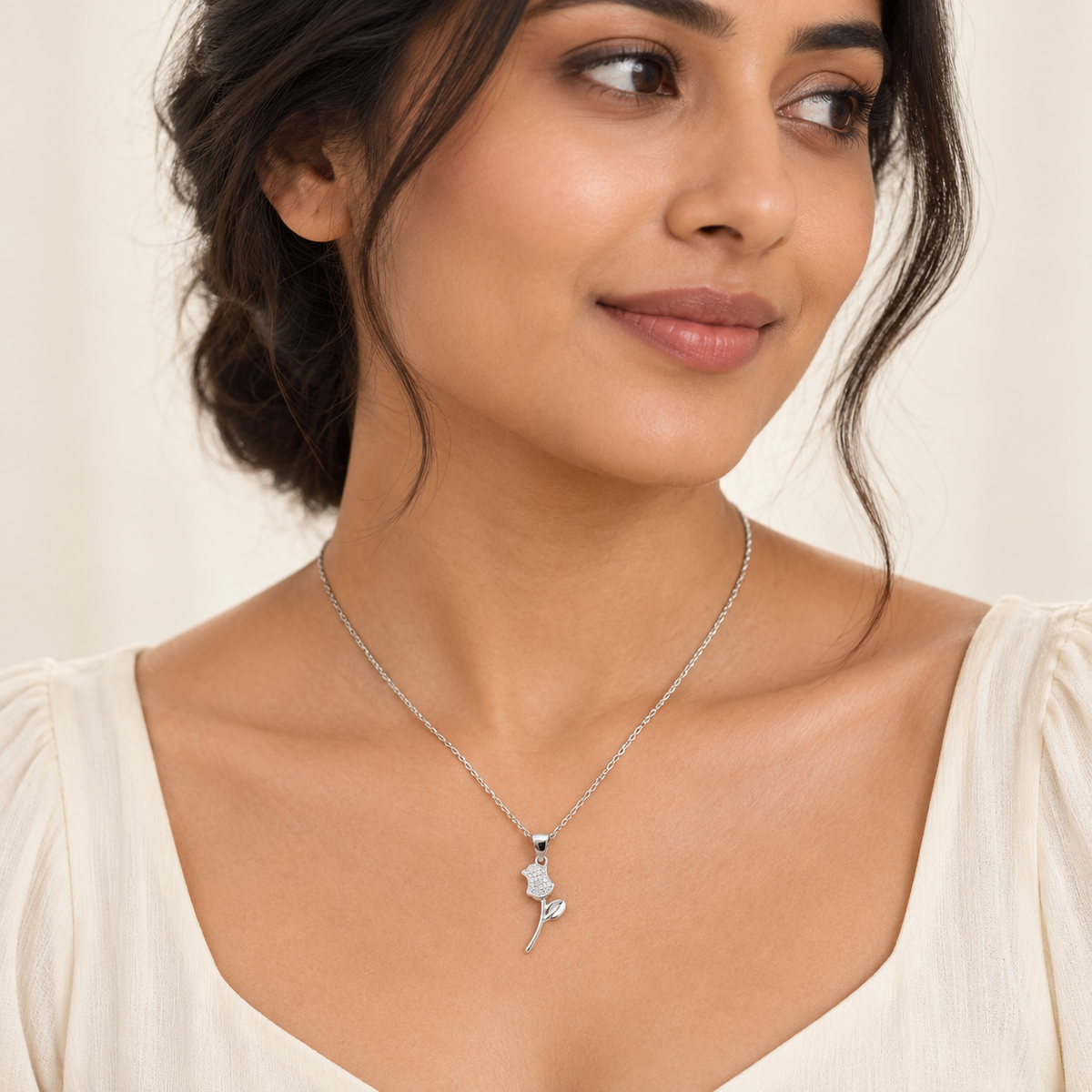 Model image: Woman wearing the delicate silver rose pendant showing its natural size and fit