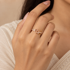 Woman wearing Amora Swirl Heart rose gold-tone ring at its actual delicate size