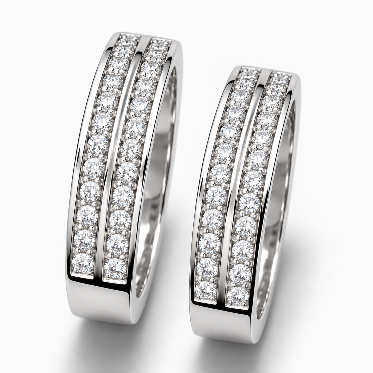 Close-up: Close-up of round clear stones, central silver dividers and polished detailing on couple rings
