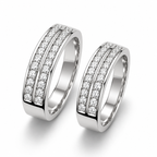 Angled view of matching silver couple rings showing dual stone rows and polished band edges