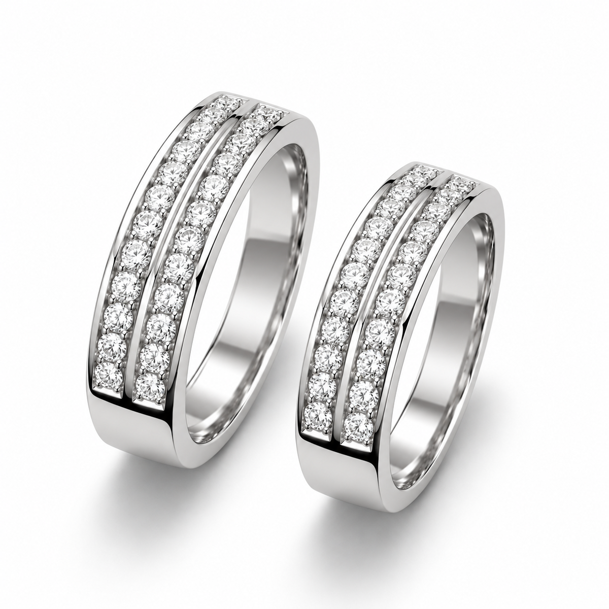 Angled view of matching silver couple rings showing dual stone rows and polished band edges