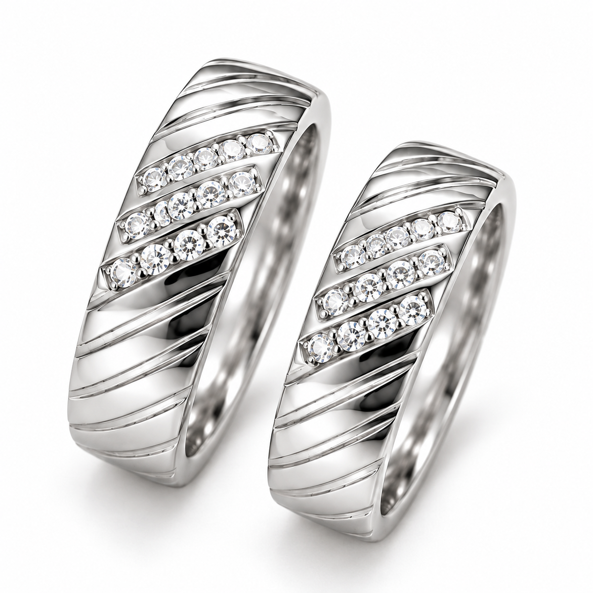 Close-up: Close-up of three clear-stone rows and diagonal detailing on matching silver couple rings