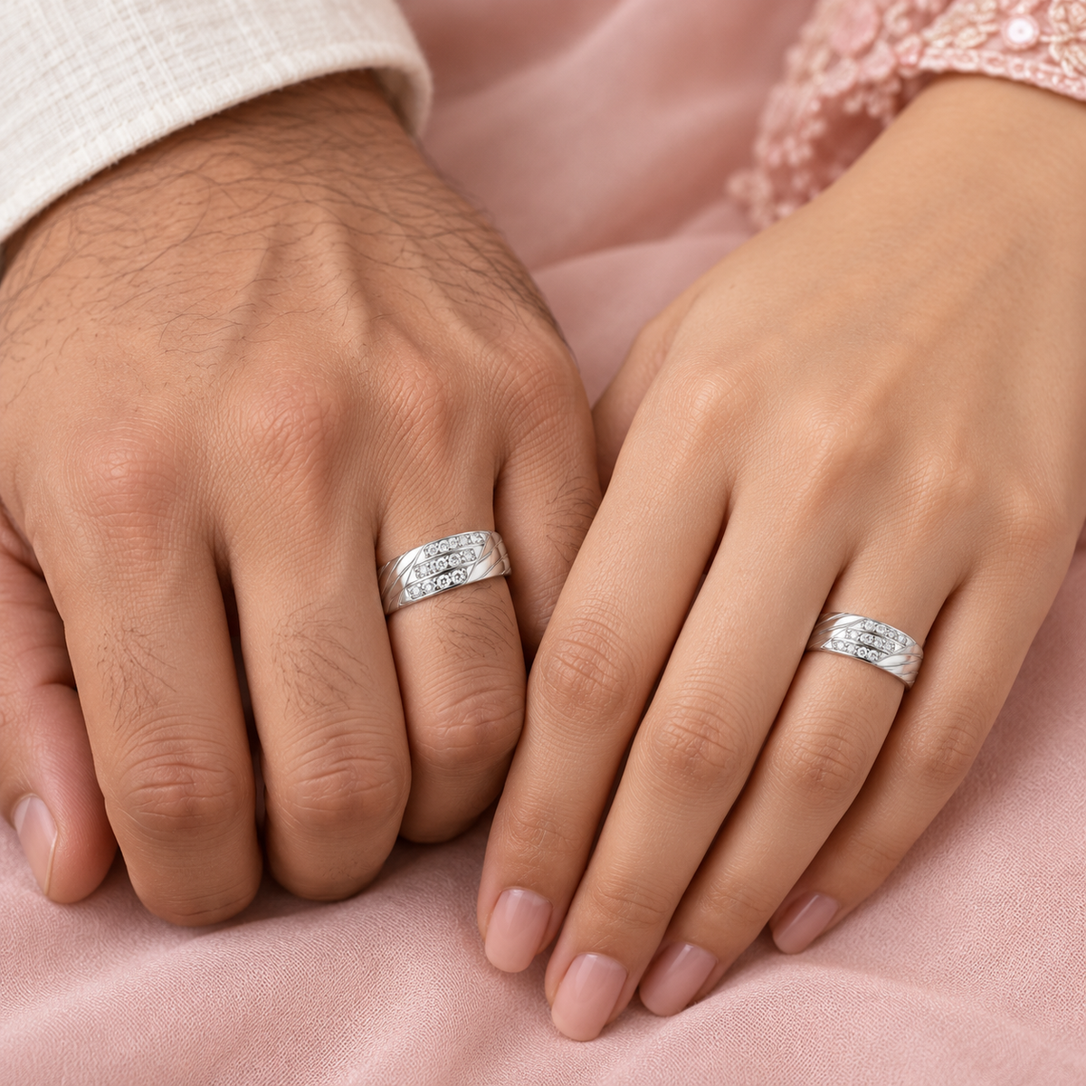 Model image: Indian couple wearing matching Entwined Spark silver rings on their ring fingers