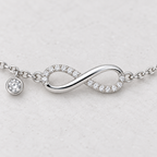 3. Close-up of pavé infinity design and bezel-set stone charm