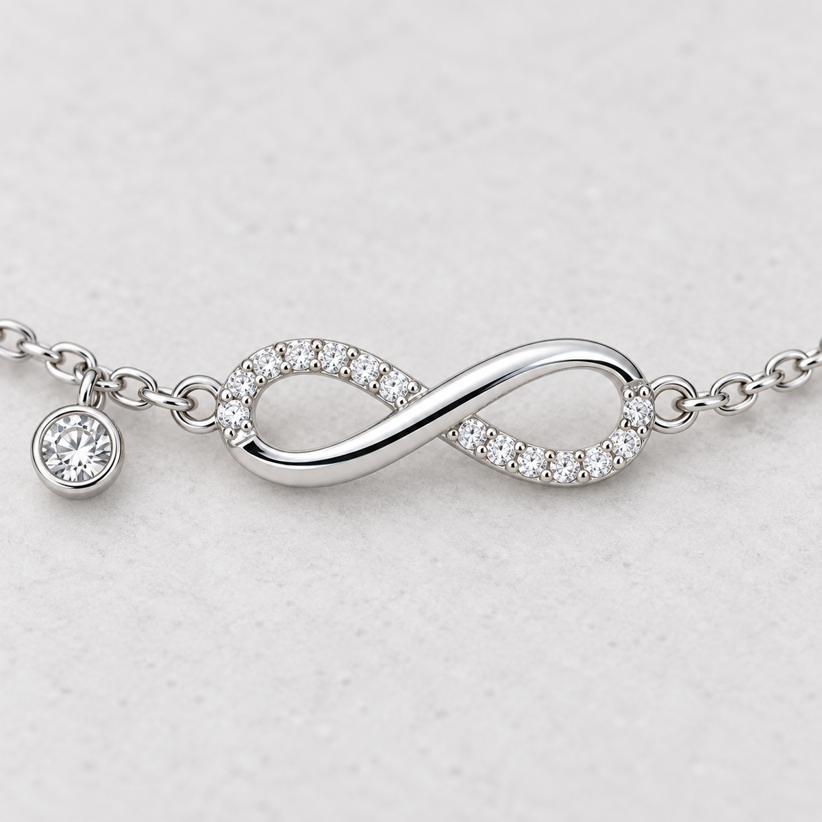 3. Close-up of pavé infinity design and bezel-set stone charm