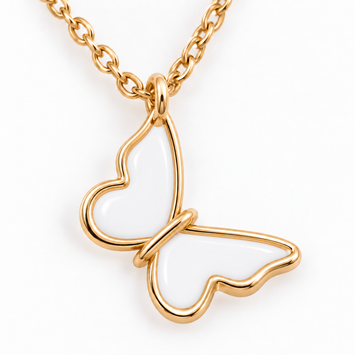 Close-up of white-filled butterfly pendant with polished gold-tone outline  
  