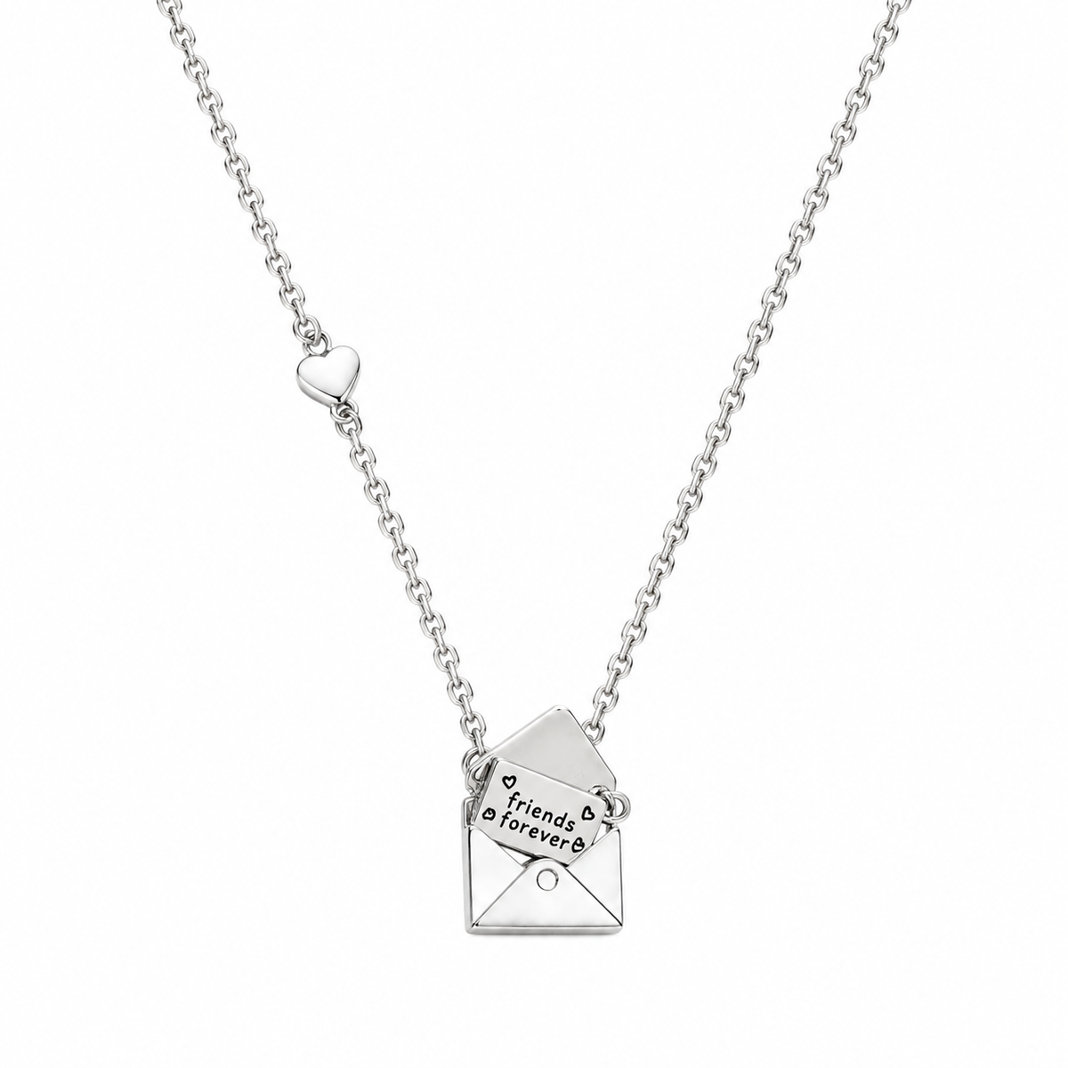 A silver chain necklace featuring a small heart-shaped charm and an open envelope pendant engraved with 'friends forever' and small heart details, shown on a plain white background.