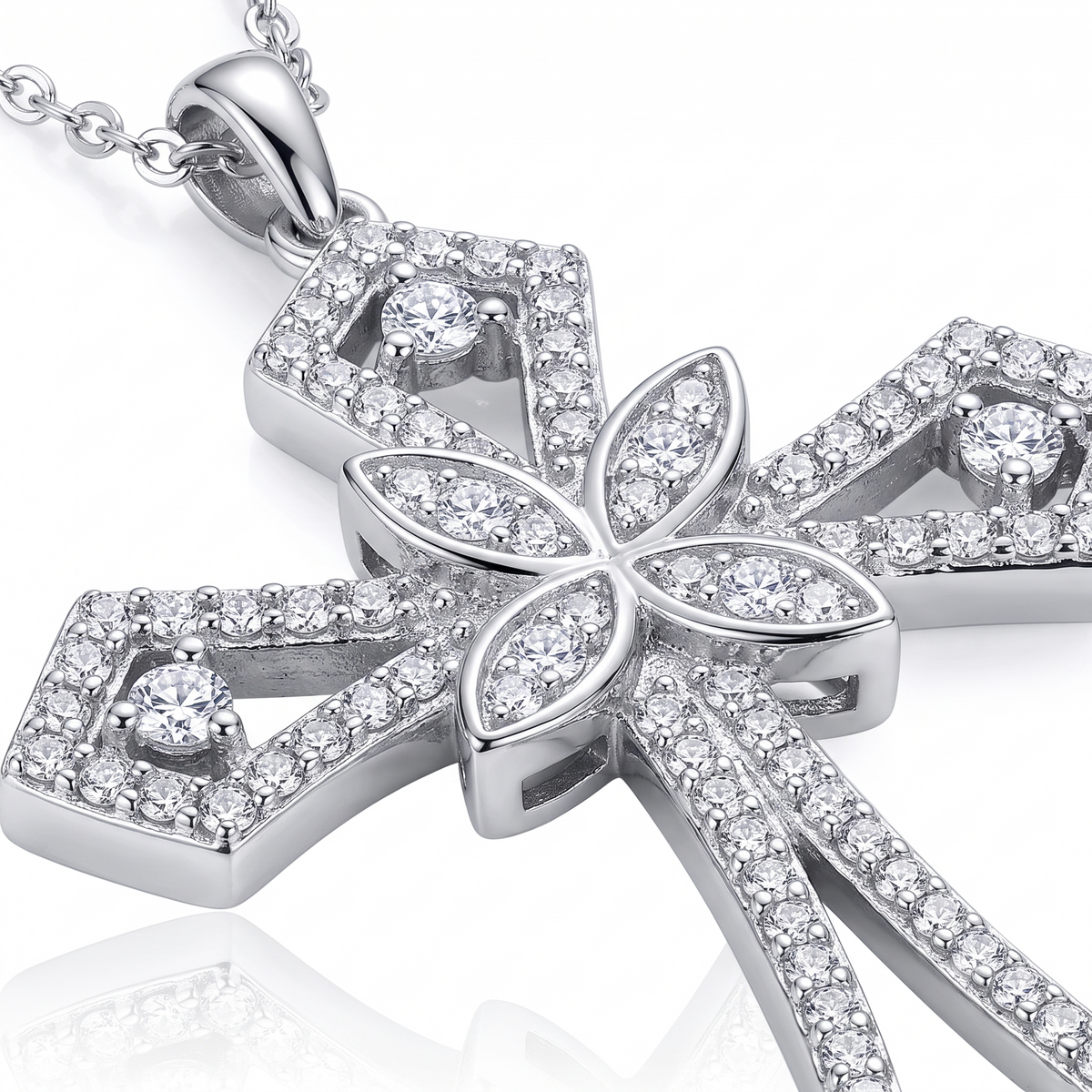 Close-up of ornate filigree cross design on sterling silver necklace
