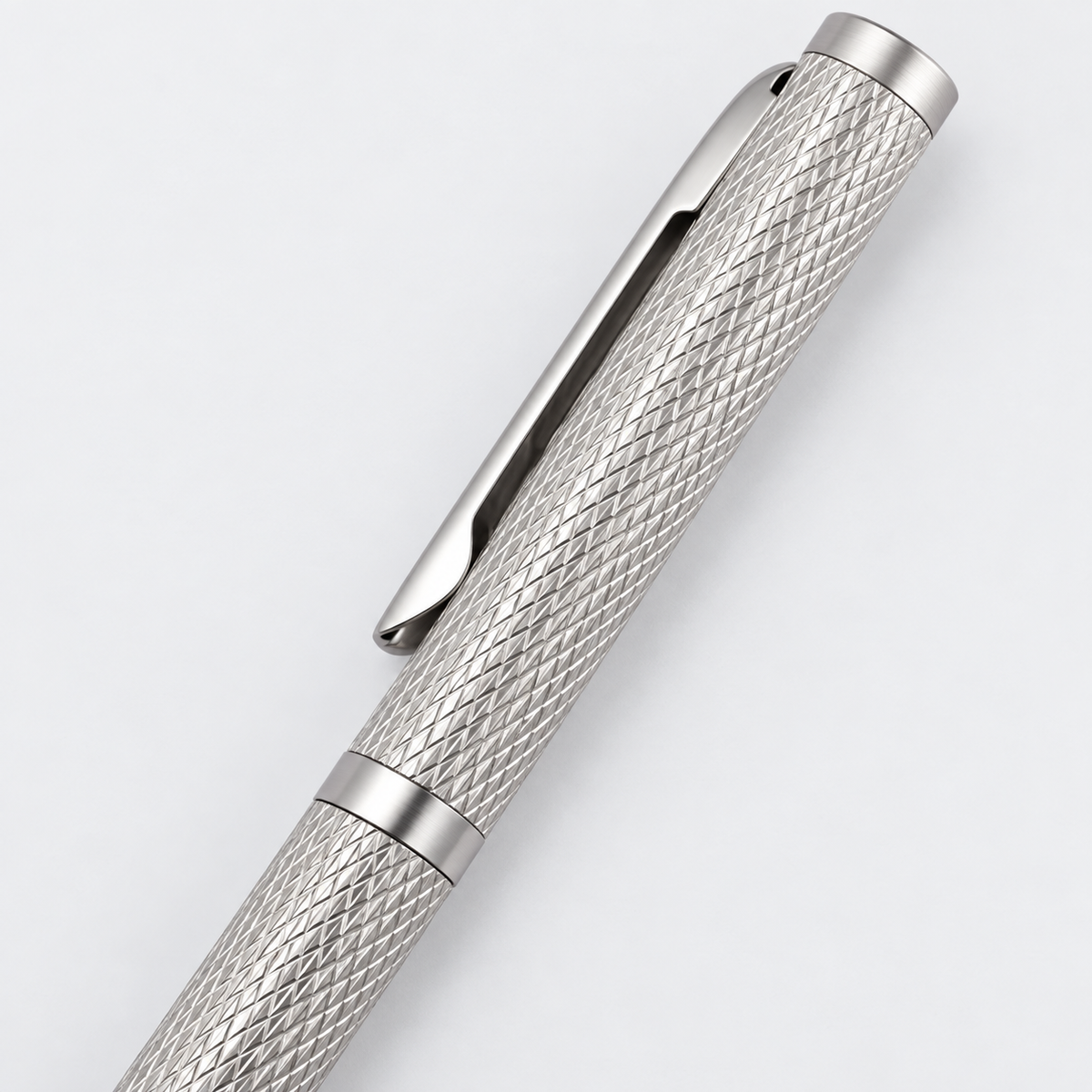 Close-up of the crosshatch texture and polished clip on a silver pen
