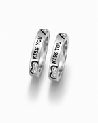 Two silver rings with engraved 'KISS YOU' text and heart-shaped clear stone details, displayed on a clean white background.
