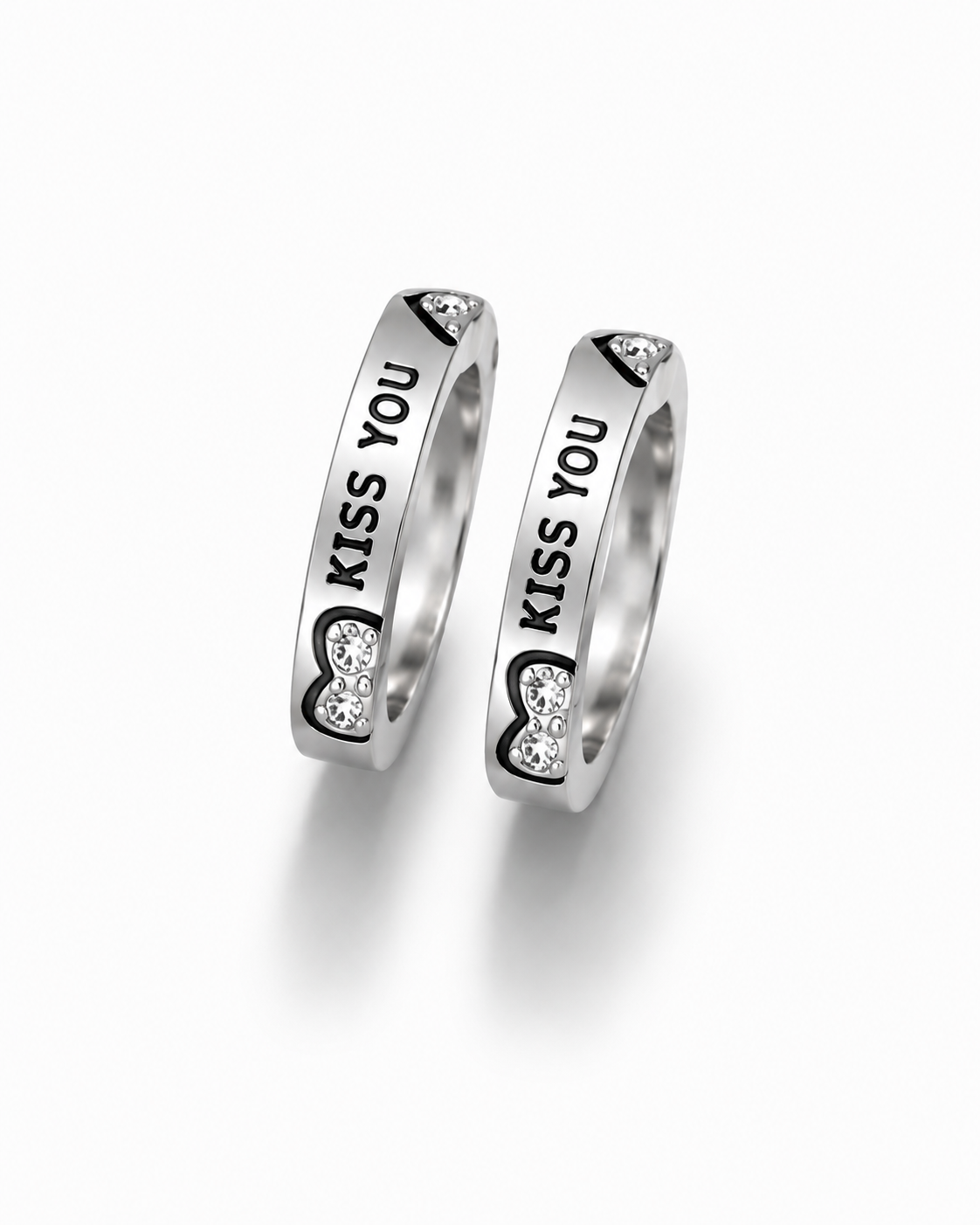 Two silver rings with engraved 'KISS YOU' text and heart-shaped clear stone details, displayed on a clean white background.