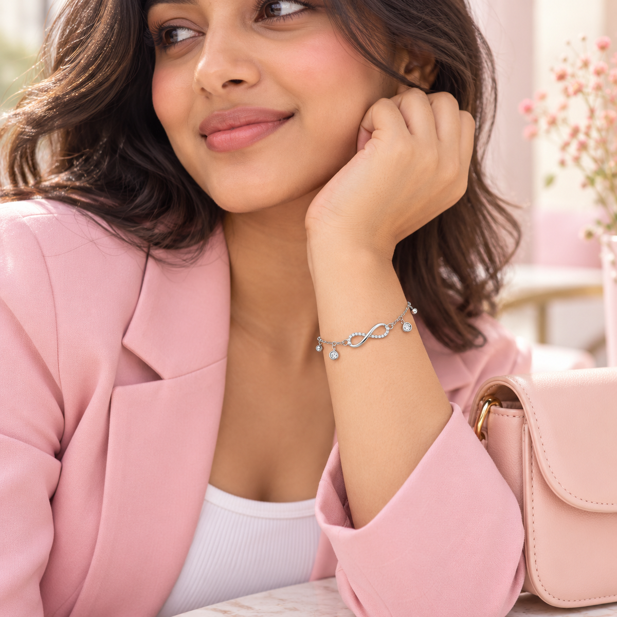 Rhodium-plated infinity bracelet styled with a Gen Z outfit
