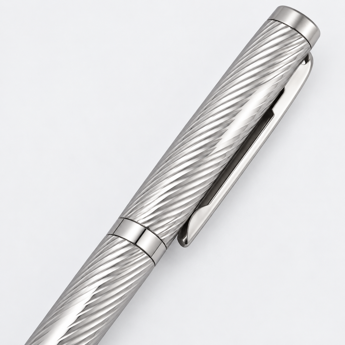 Close-up of diagonal wave-cut detailing and polished silver pen clip

